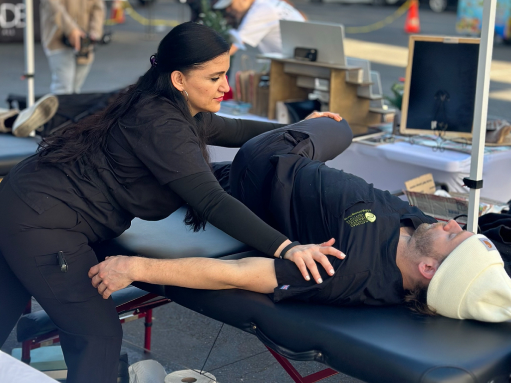 sports massage therapist stretching an athlete